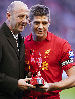 Liverpool captain Steven Gerrard (right) is presented with a statue of a Liver bird by former player Gary McCallister as he makes his 600th appearance in the English Premier League soccer match against Newcastle United on Sunday