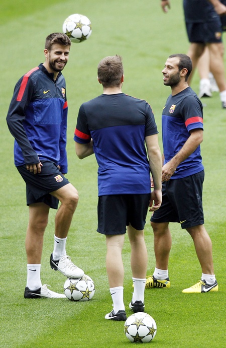 Barcelona's Gerard Pique, Marc Bartra and Javier Mascherano