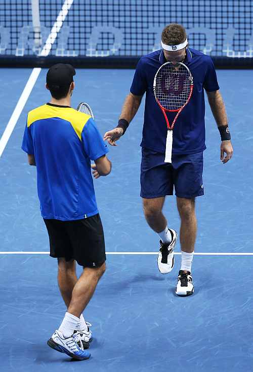 Horia Tecau of Romania and Robert Lindstedt of Sweden react during the men's doubles match against Mahesh Bhupathi of India and Rohan Bopanna of India