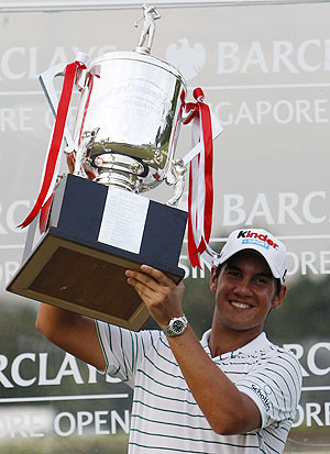 Matteo Manassero of Italy with his trophy after winning the Singapore Open golf tournament in Sentosa on Sunday