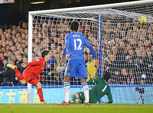 Liverpool's Luis Suarez (left) heads to score against Chelsea during their Premier League match at Stamford Bridge on Sunday