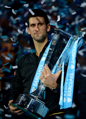 Novak Djokovic of Serbia lifts the trophy after the men's singles final against Roger Federer of Switzerland at the ATP World Tour Finals