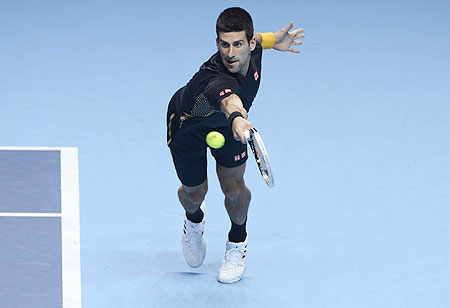 Serbia's Novak Djokovic plays return against Switzerland's Roger Federer during their final of the ATP World Tour Finals on Tuesday