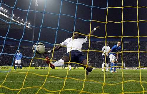 France's Bafetimbi Gomis (C) shoots to score a second goal against Italy