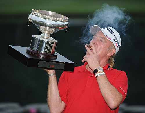 Miguel Angel Jimenez of Spain with the winners trophy and his cigar after the final round of the UBS Hong Kong open at The Hong Kong Golf Club