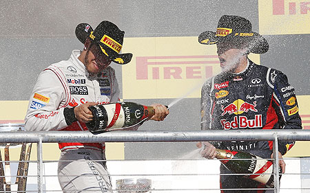 McLaren's Lewis Hamilton (left) and Red Bull's Sebastian Vettel spray champagne during the podium ceremony after the US Grand Prix at the Circuit of the Americas in Austin, Texas on Sunday