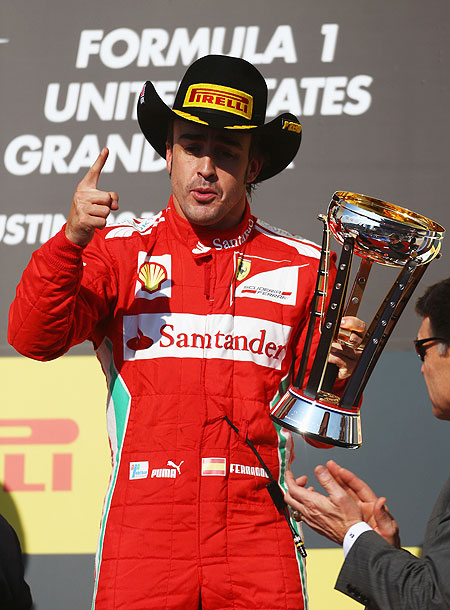 Fernando Alonso of Ferrari celebrates on the podium after finishing third at the US Grand Prix at the Circuit of the Americas on Sunday