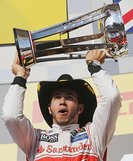 McLaren's Lewis Hamilton holds up his trophy on the podium after winning the US F1 Grand Prix at the Circuit of the Americas in Austin, Texas on Sunday