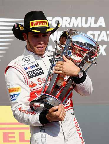 Lewis Hamilton of Great Britain and McLaren celebrates on the podium after winning the United States Formula One Grand Prix