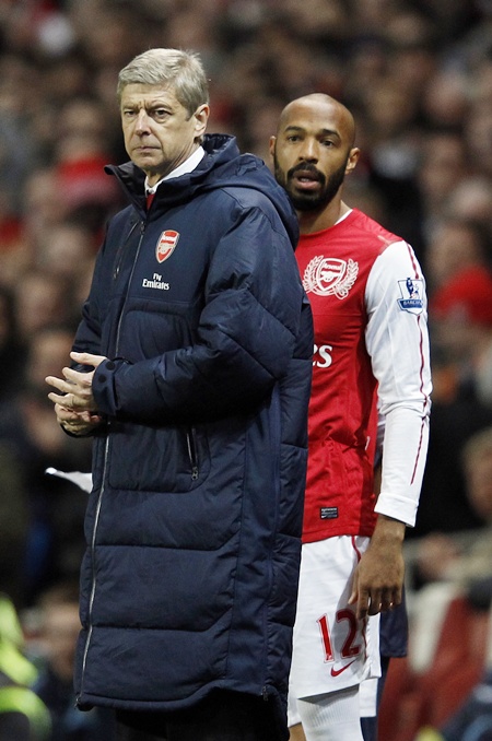 Thierry Henry looks on beside manager Arsene Wenger