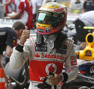 McLaren Formula One driver Lewis Hamilton celebrates after taking the pole position during qualifying at the Brazilian GP