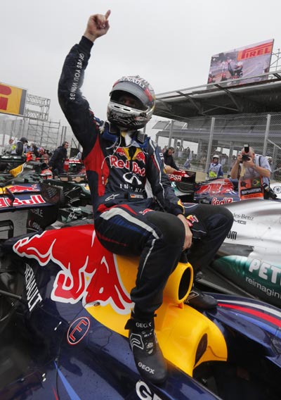 Red Bull Formula One driver Sebastian Vettel of Germany celebrates winning the world championship after finishing sixth in the Brazilian F1 GP