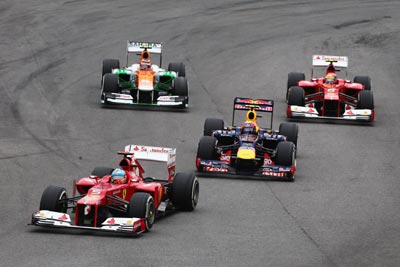 Fernando Alonso of Spain and Ferrari leads from Mark Webber of Australia during Brazil GP