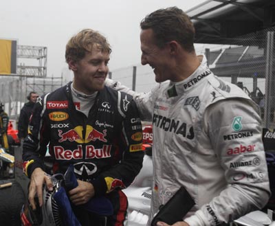 Mercedes Formula One driver Michael Schumacher of Germany (R) congratulates compatriot Red Bull driver Sebastian Vettel after the Brazilian F1 Grand Prix