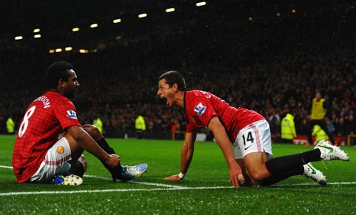 Javier Hernandez of Manchester United celebrates scoring his team's third goal with team-mate Anderson (L) to make the score 3-1 during the Barclays Premier League match between Manchester United and Queens Park Rangers