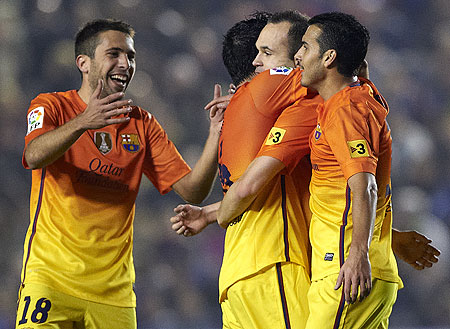 Barcelona's Andres Iniesta celebrates with teammate Pedro Rodriguez (right), Jordi Alba (left) and Xavi Hernandez after scoring against Levante on Sunday