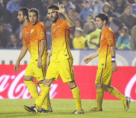 Barcelona's Cesc Fabregas (centre) celebrates with teammates after he scoring against Levante on Sunday