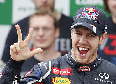 Red Bull Formula One driver Sebastian Vettel celebrates winning the world championship with his team after the Brazilian F1 Grand Prix on Sunday