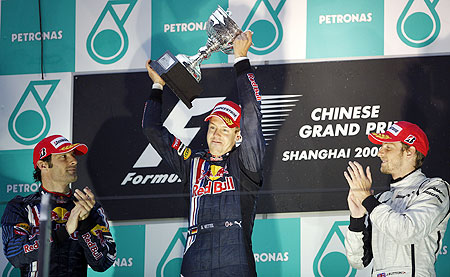 Red Bull's Sebastian Vettel (centre) celebrates with his trophy after winning the Chinese F1 Grand Prix in Shanghai on April 19, 2009