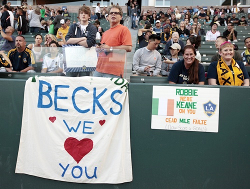 Fans display signs supporting David Beckham and Robbie Keane
