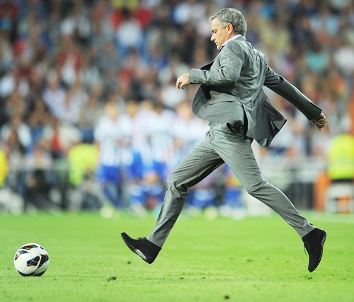 Head coach Jose Mourinho of Real Madrid kicks the ball