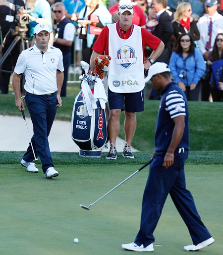 Francesco Molinari of Europe looks on as Tiger Woods of the USA misses his par putt