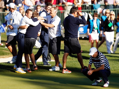 Jim Furyk of the USA (right) reacts to a missed par putt on the 18th green as Sergio   Garcia and the European team celebrate
