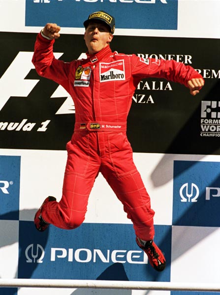 Ferrari driver Michael Schumacher jumps for joy on the podium after winning a stunning race after the Italian GP, held in Monza, Italy, on September 8, 1996