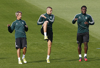 Real Madrid's Fabio Coentrao (left), Karim Benzema (centre) and Michael Essien warm up during a team training session