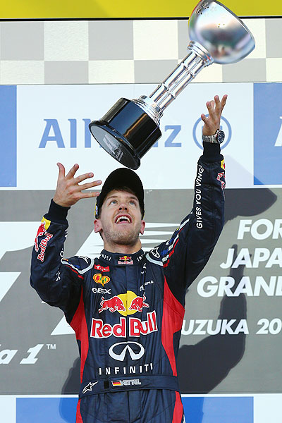 Red Bull Racing's Sebastian Vettelcelebrates on the podium after winning the Japanese GP on Sunday