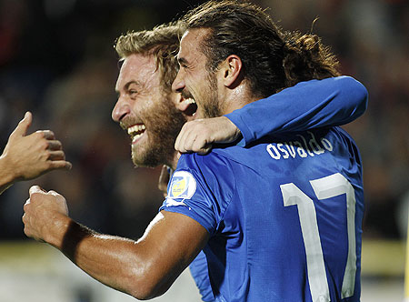 Italy's Pablo Osvaldo (right) celebrates with teammate Daniele De Rossi after scoring a goal against Armenia