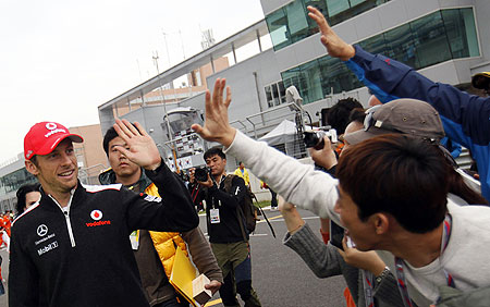 McLaren Formula One driver Jenson Button (left) greets fans before an autograph signing session at the Korea International Circuit  in Yeongam