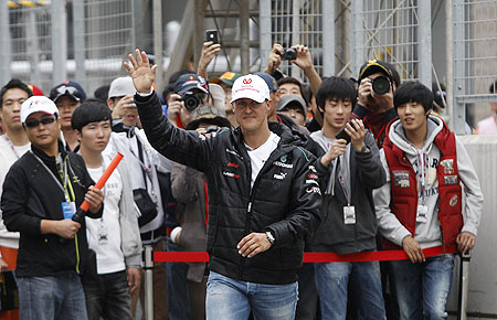 Mercedes driver Michael Schumacher waves to fans before an autograph signing session at the Korea International Circuit in Yeongam