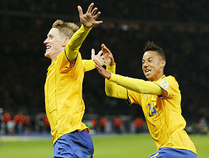 Sweden's Rasmus Elm celebrates with his teammate Tobias Sana (right) after scoring against Germany during the World Cup qualifier in Berlin on Tuesday