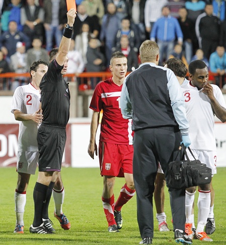 Referee Huseyin Gocek shows the red card to Danny Rose (right) of England