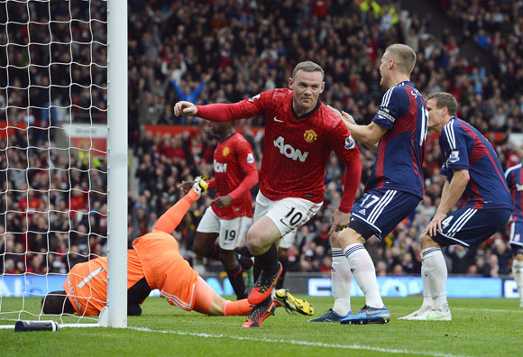 Manchester United's Wayne Rooney (C) celebrates scoring against Stoke City during their English Premier League match