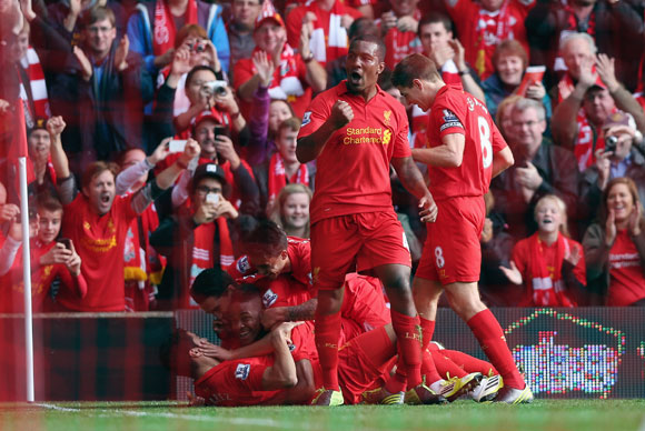 Raheem Sterling of Liverpool celebrates with his team-mates after scoring against Reading at Anfield