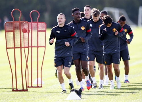 Manchester United's Tom Cleverley (left) runs during a training session