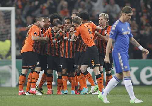 Shakhtar Donetsk players celebrate a goal near Chelsea's Torres during their Champions League Group E soccer match at the Donbass Arena in Donetsk