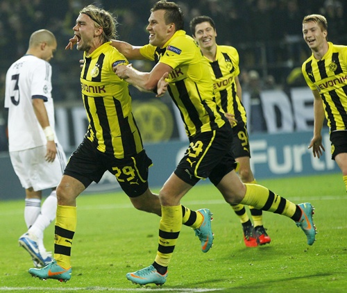Borussia Dortmund's Marcel Schmelzer (centre) celebrates with his teammates   Kevin Grosskreutz and Robert Lewandowski after scoring a goal against Real   Madrid