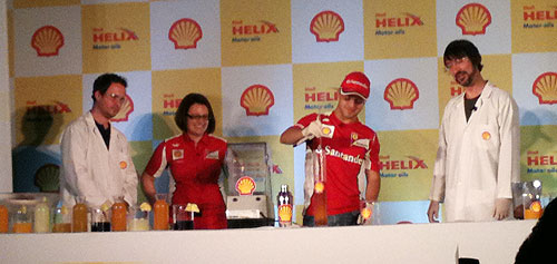 Ferrari's Felipe Massa (centre) prepares a cocktail drink at a press event on Thursday