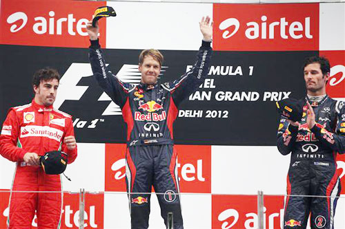 Fernando Alonso of Ferrari, Sebastian Vettel of Red Bull   Racing and Mark Webber Red Bull celebrate on the podium