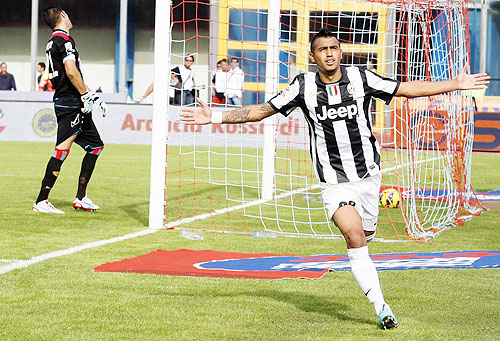 Juventus' Arturo Vidal (right) celebrates after scoring against Catania on Sunday