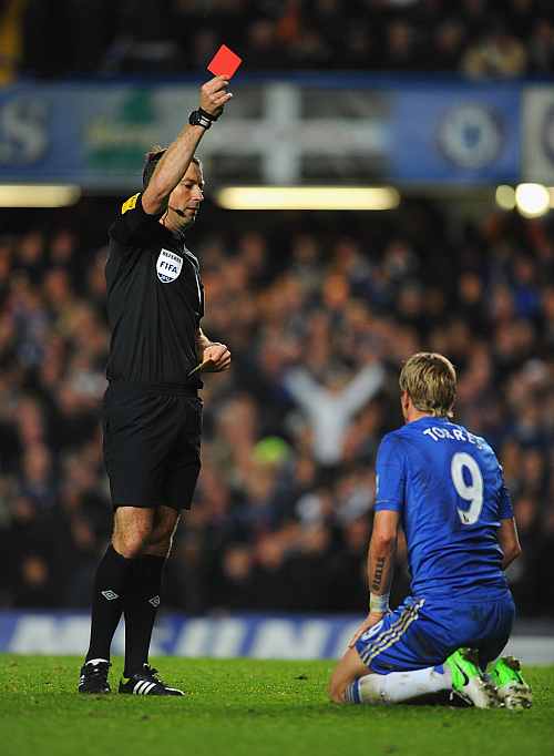 Fernando Torres of Chelsea is shown the red card by referee Mark Clattenburg during the Barclays Premier League match between Chelsea and Manchester United