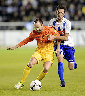 Barcelona's Andres Iniesta (left) and Deportivo Alaves' Guzman Casaseca vie for possession during their Spanish King's Cup match on Tuesday