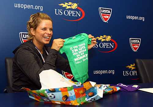 Kim Clijsters of Belgium opens gifts from members of the Belgian media