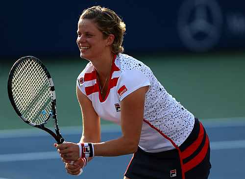 Kim Clijsters of Belgium reacts during a first round mixed doubles match with her partner Bob Bryan