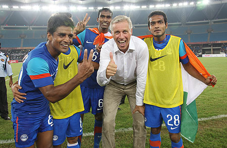 Indian players celebrate with coach Wim Koevermans after winning the Nehru Cup on Sunday