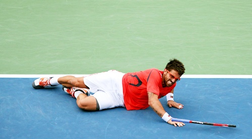 Janko Tipsarevic of Serbia slips on the court