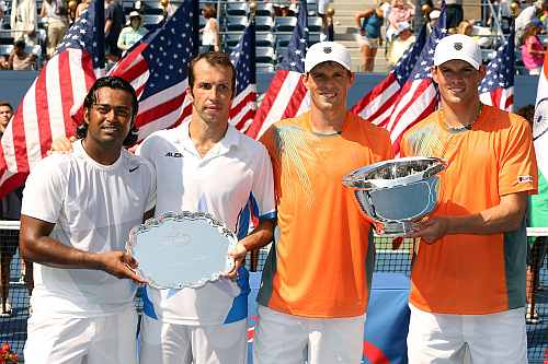 Bob Bryan (R) and Mike Bryan pose with the trophy next to Leander Paes and Radek Stepanek after their men's doubles final match of the 2012 US Open